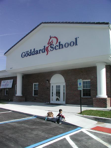 PC140013.JPG - In January 2010, Rohan started school. Here he is sitting at the kerb with his mothers handbag by his side