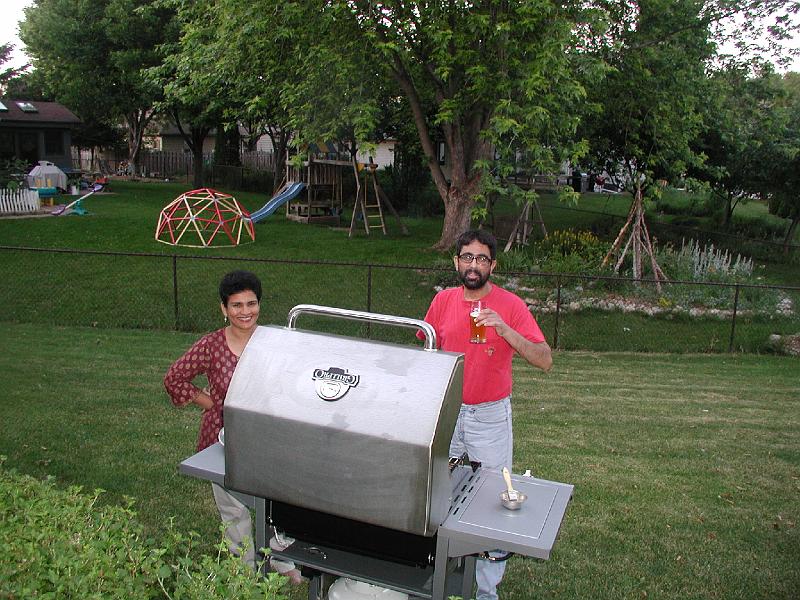 P7040014.JPG - I was manning the grill. Sujatha came to see what was cooking.