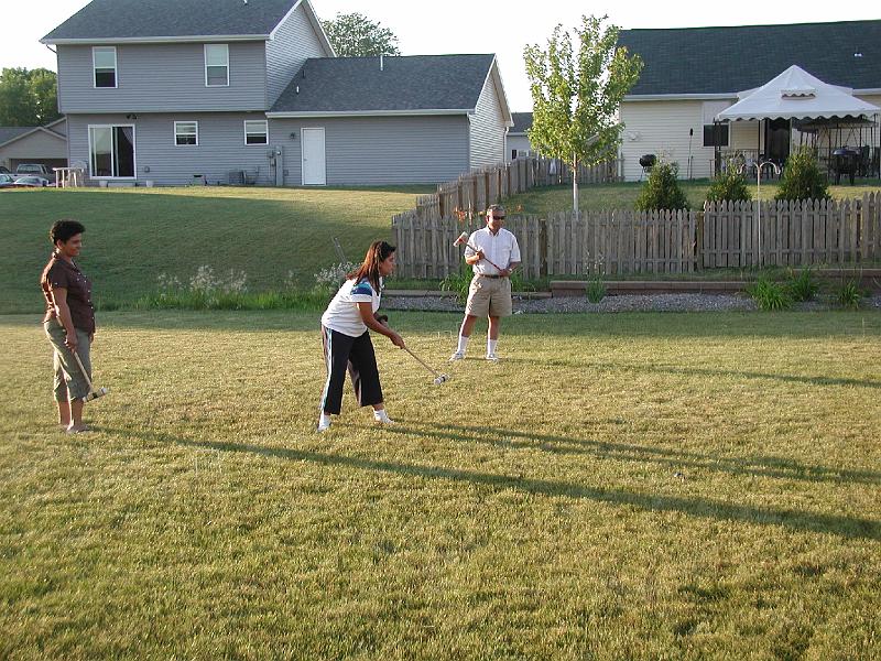 P7050058.JPG - Three years ago during the last Halarnkar reunion in Neenah, the person in the house with the white tent had set his gas grill on fire. This year he did not provide any such entertainment. He never showed his face. As you can see he has migrated to a charcaol grill - much safer.
