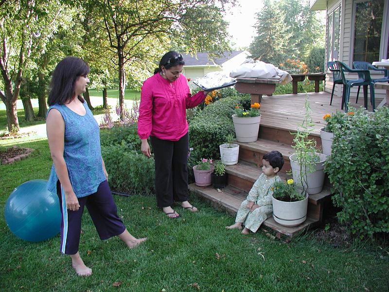 P7060041.JPG - Rohan sat quietly on the deck steps till the food was ready. Here Kavitha is asking him if he wanted a sample